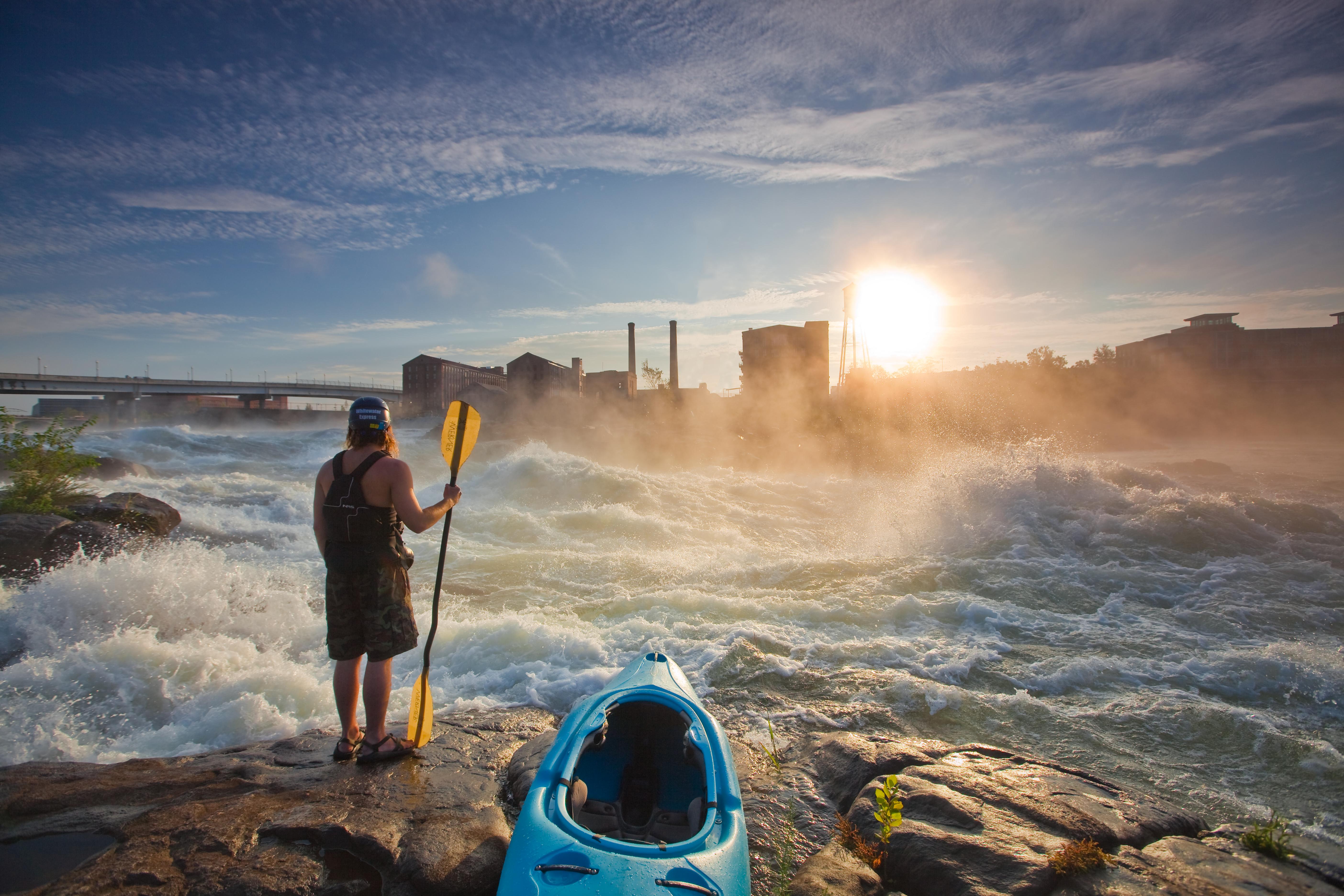 Man looking out at a Georgia River holding his Kayak paddle