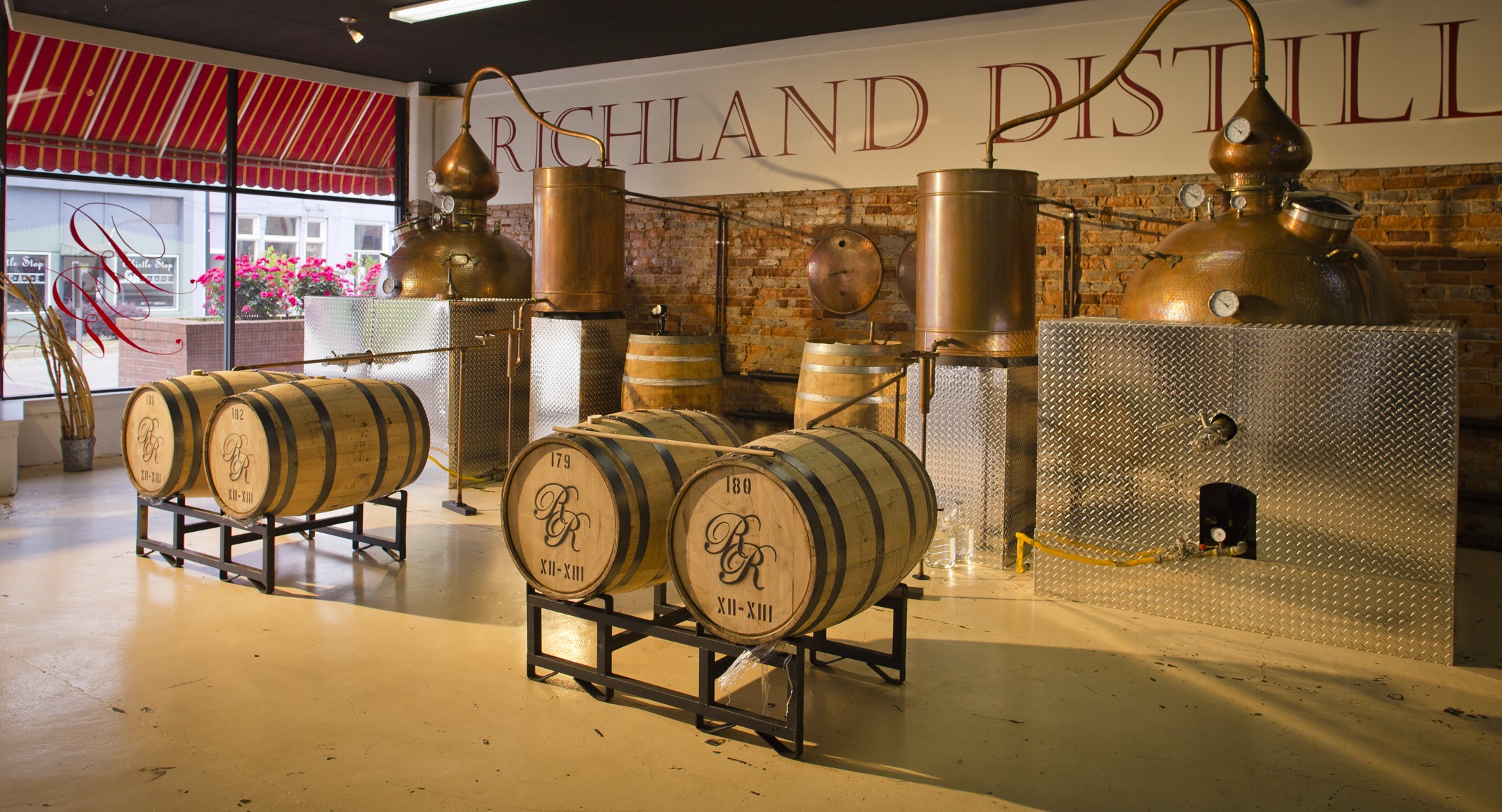 Distilleries like Richland Rum showcase the equipment used to create unique flavors, such as machinery and barrels. 