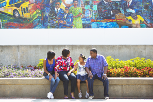 Family in front of mural