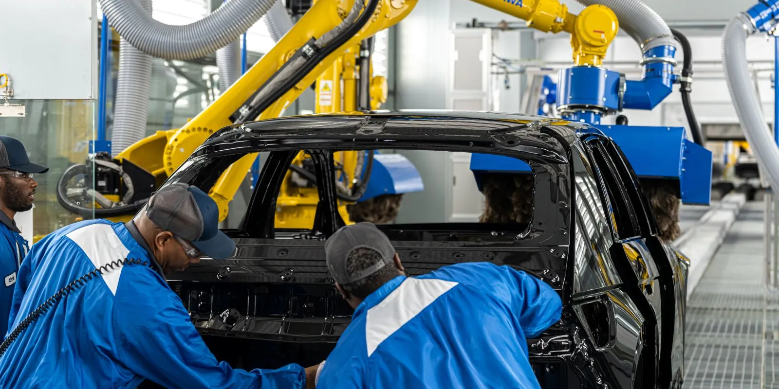 Employees at Hyundai Motor Group Metaplant America working on a car