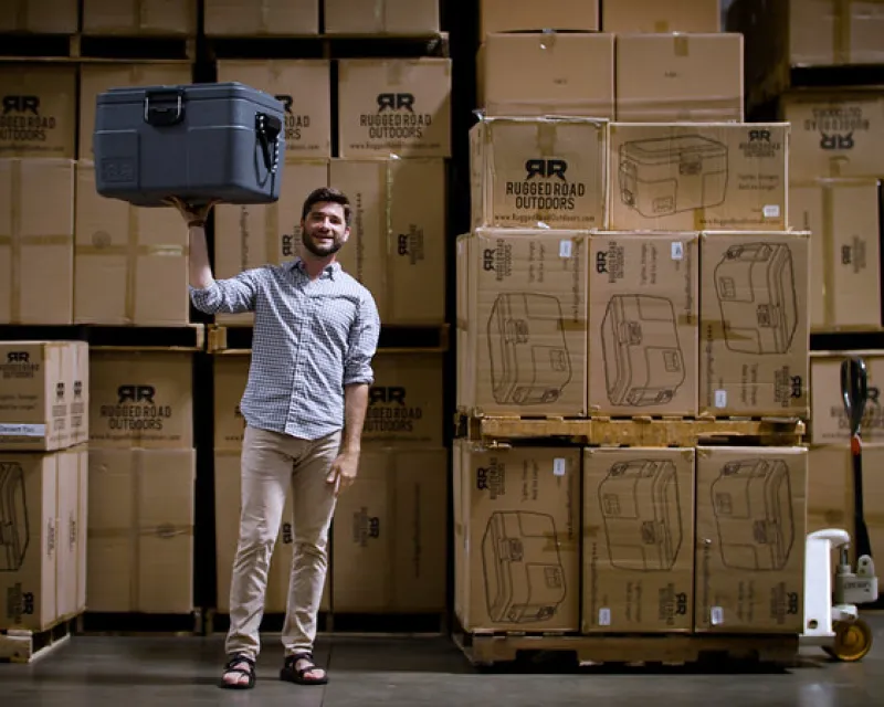 Man posing Infront of boxes