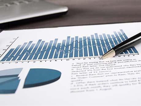 reports reports are highlighted on a piece of paper with a pen resting on it