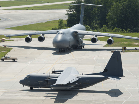 One large and one small gray United States Air Force planes are parked in an airport lot in Georgia.