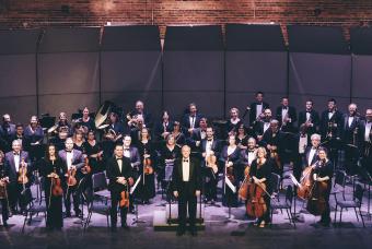 A large Orchestra performing on set in Georgia