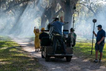 A video camera captures an actress from the Color Purple performing among beautiful trees in Georgia