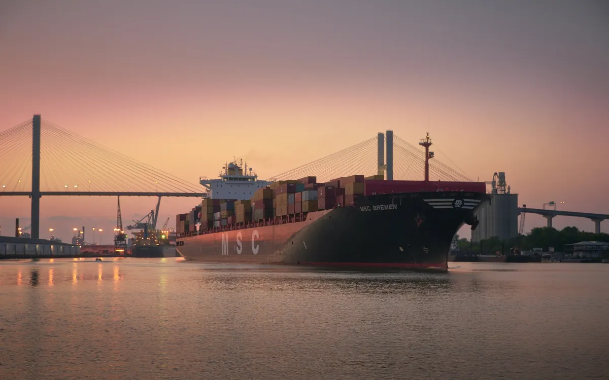 Cargo ship in Savannah River at sunset