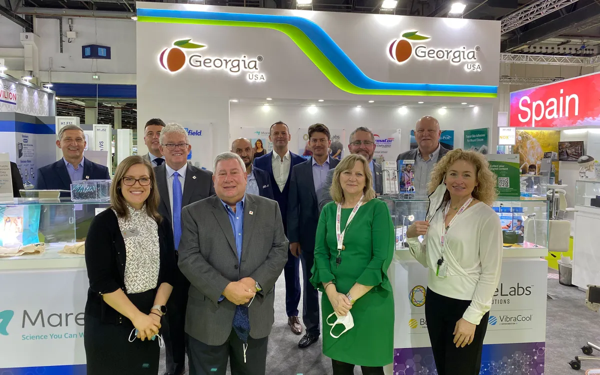 Group poses in Georgia booth at Arab Health 2022