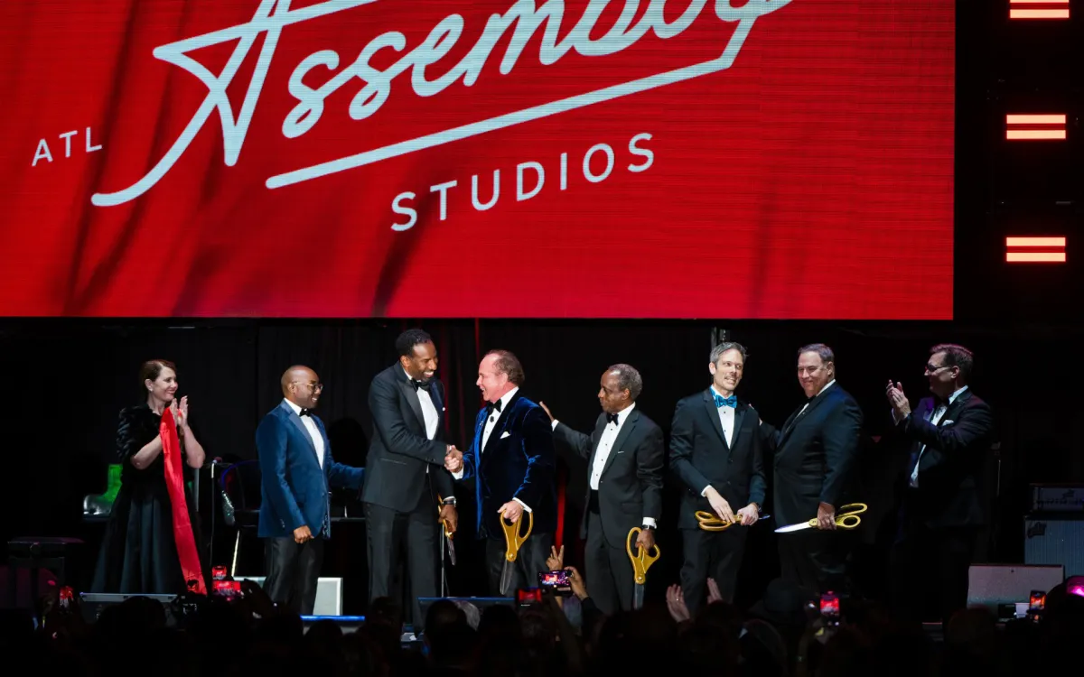 Group on stage at ribbon cutting of Assembly Atlanta film studio complex in Doraville