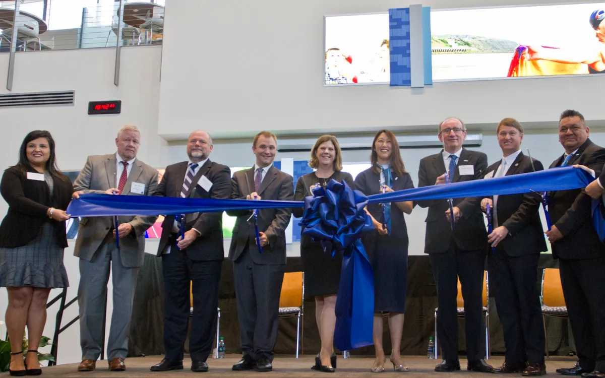 people cutting a ribbon