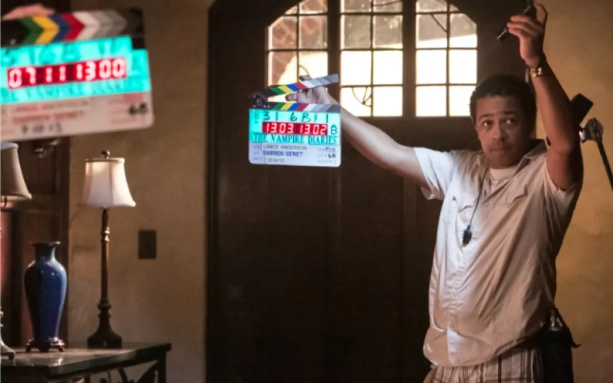 Man holds a slate on The Vampire Diaries set