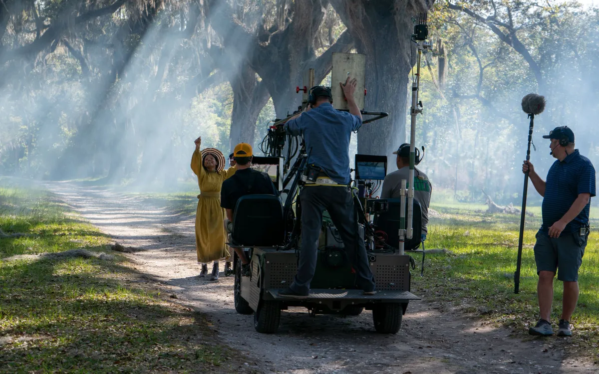 A video camera captures an actress from the Color Purple performing among beautiful trees in Georgia
