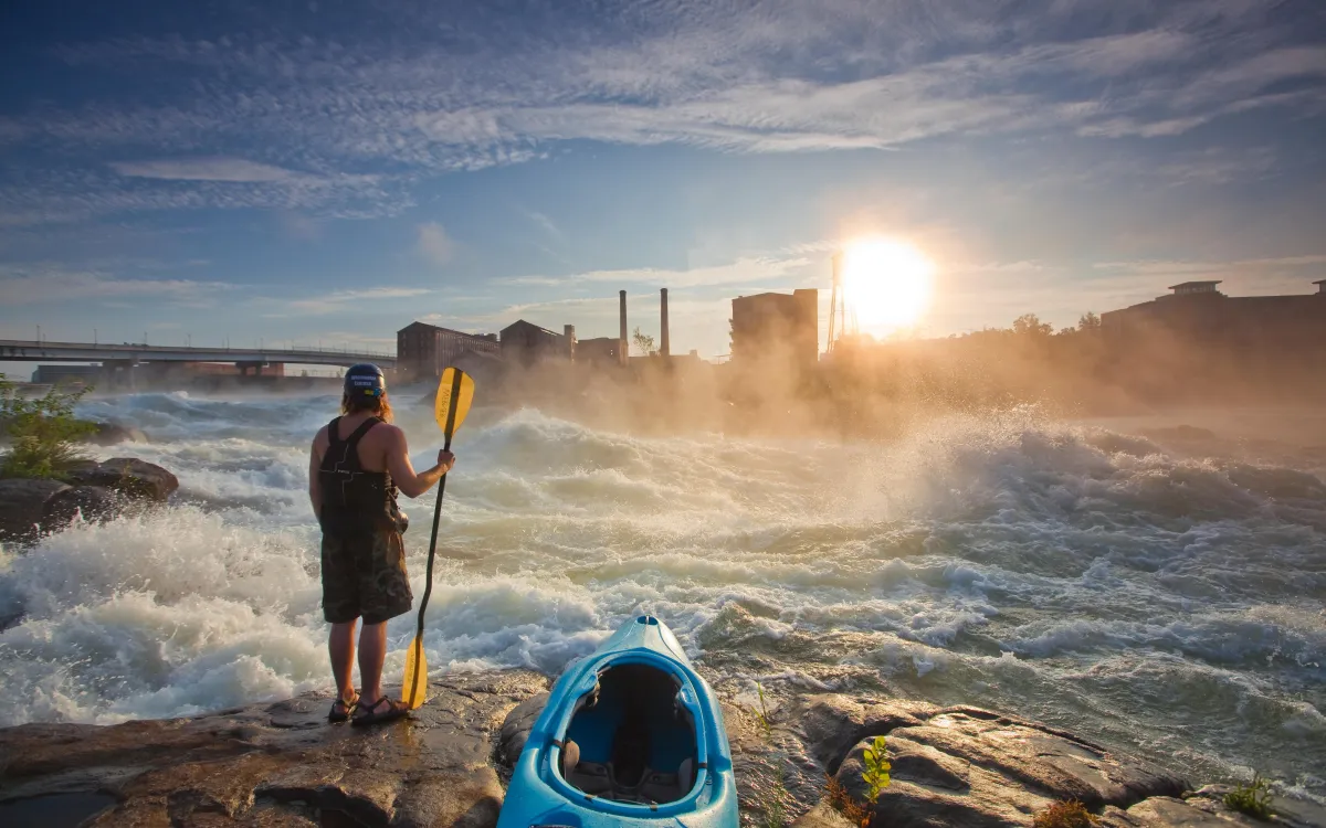 Man looking at Georgia river with his Kayak and paddle