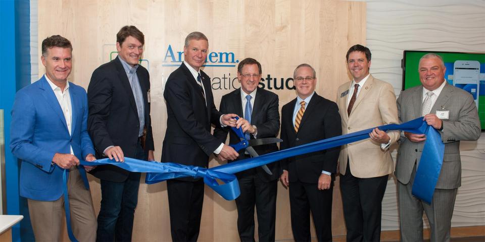 several people in business attire anthem ribbon cutting