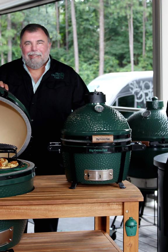 Leaders from Big Green Egg based in Metro Atlanta smile while holding cooking products