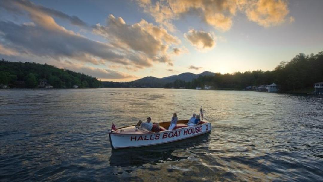 A boat floats on water at sunset at Lake Rabun Boating