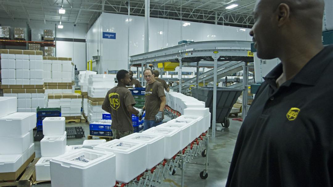 People working in UPS factory interior, based in Metro Atlanta