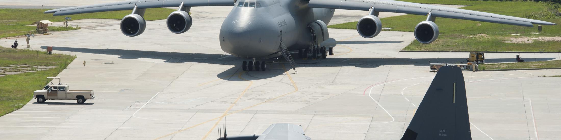 Two gray United States Air Force planes parked in a lot in Georgia
