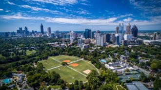 Midtown Atlanta, sprawling green fields and skyscrapers on a sunny day