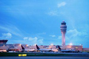 Exterior of Hartsfield-Jackson International Airport with planes, in the evening