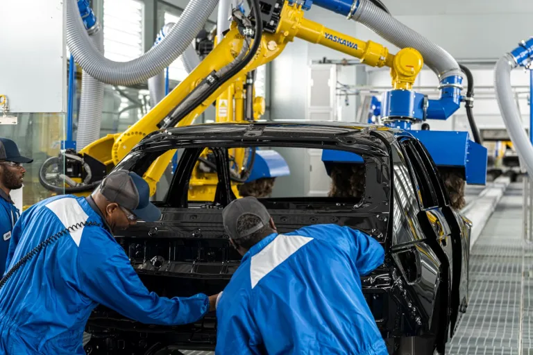 Employees at Hyundai Motor Group Metaplant America working on a car