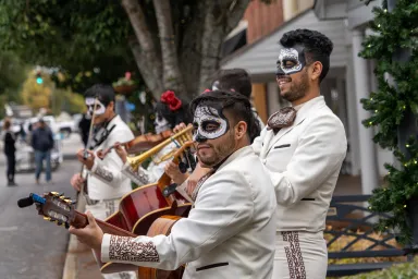 People playing instruments in the city square