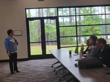 Woman gives a presentation to Georgia's international representatives