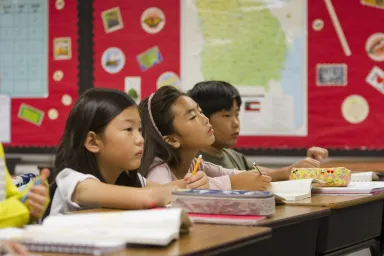 Kids sitting in a classroom at school