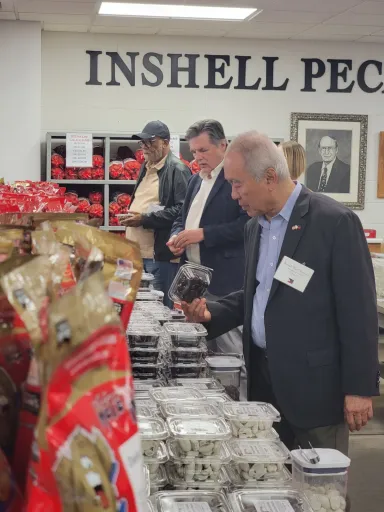 People sampling pecans.