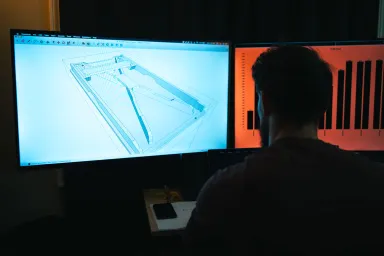 Worker designing a custom cornhole board