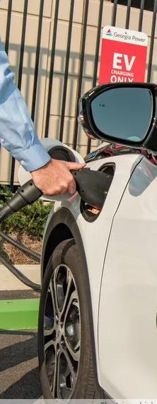 Person charging their electric vehicle