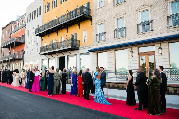 People in formal wear on a red carpet at Assembly Atlanta studios in Doraville, Georgia