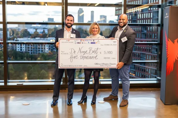 Three Dr. Noze Best representatives pose with enlarged check for $5,000
