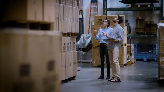 Two people at a warehouse