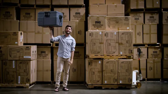 Man posing Infront of boxes